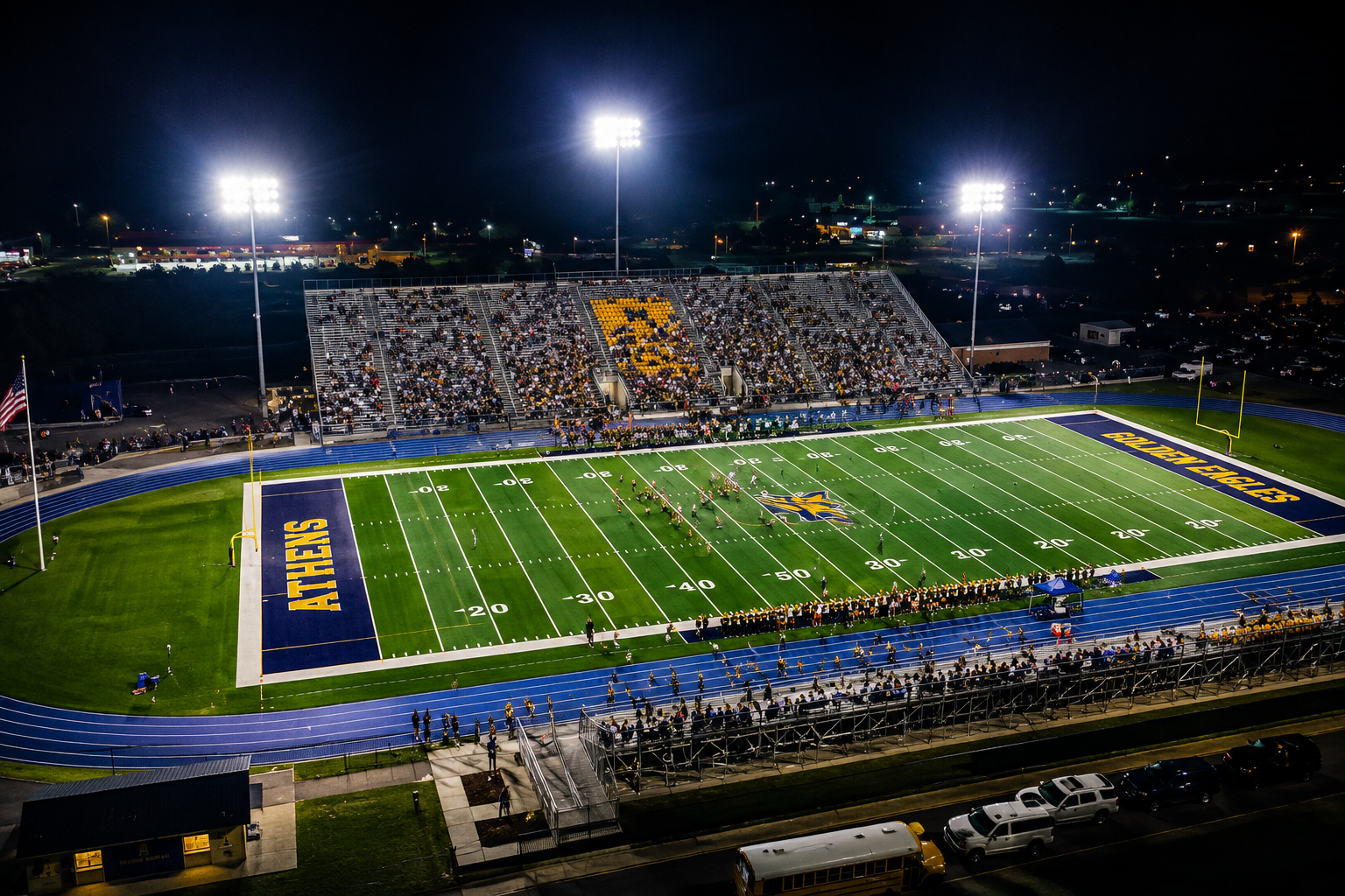 Youth football players under Friday night stadium lights in Alabama